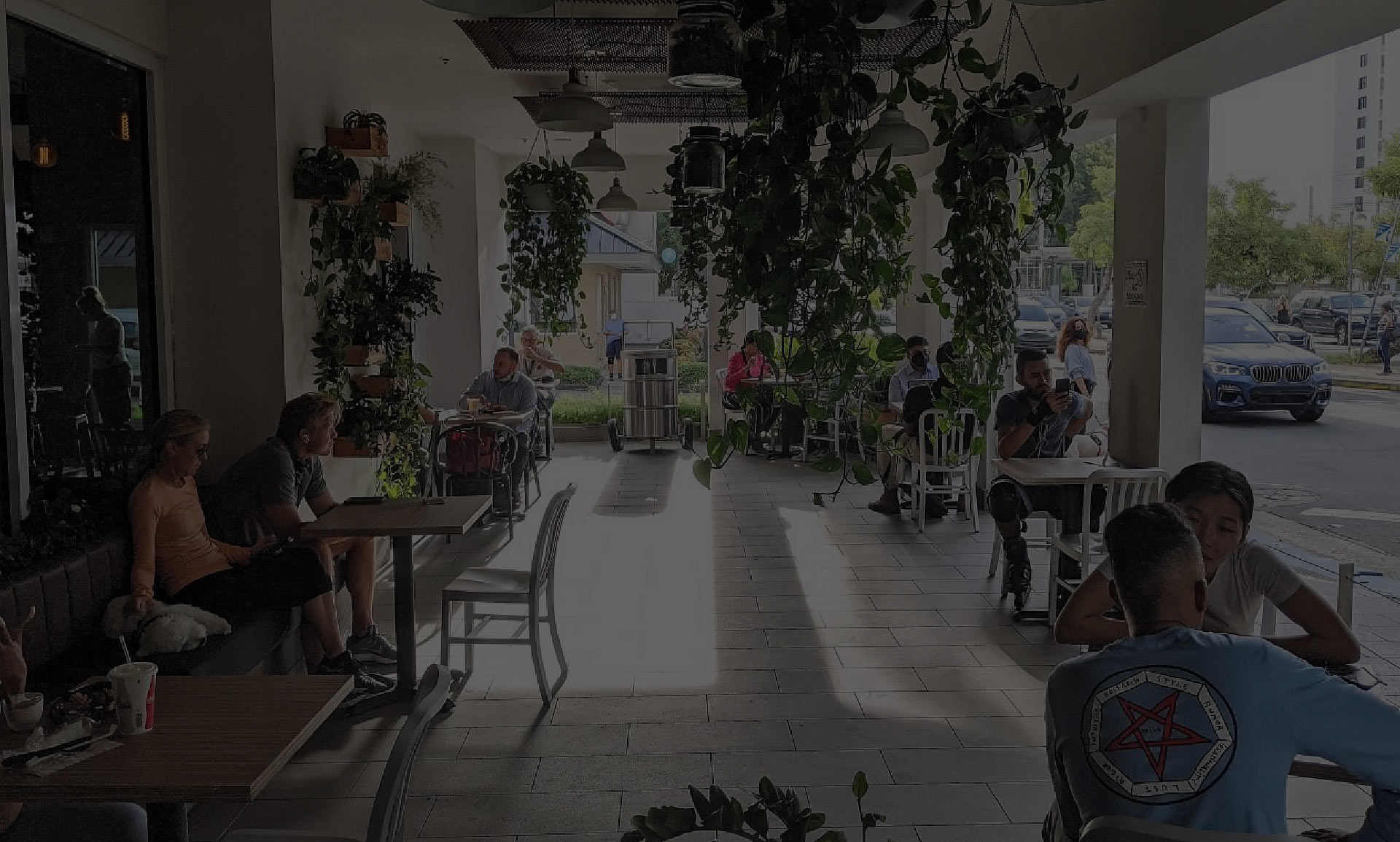 an overlayed photo of customers in the Sobao restaurant terrace