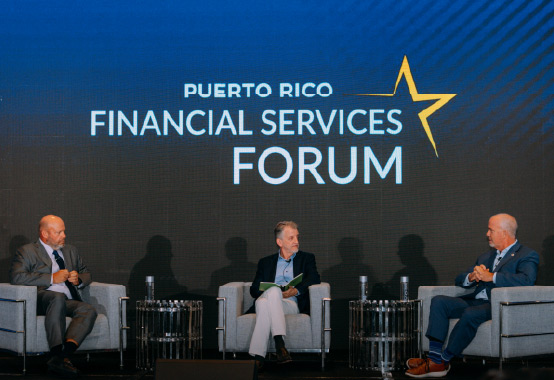three men on stage at an event