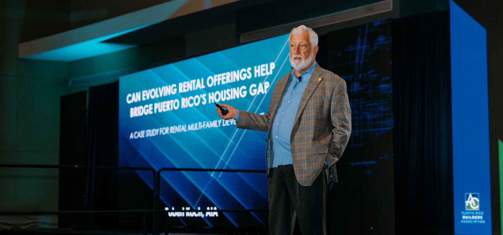 a photo of a speaker on stage