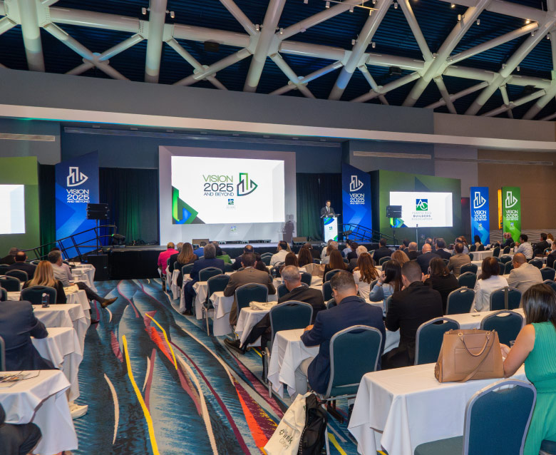 photo of attendees in their chairs watching a speaker