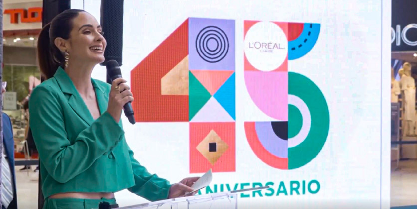 a woman speaking at a L'Oréal Caribe event